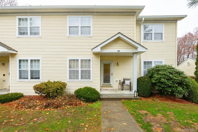 a view of a house with a yard and plants