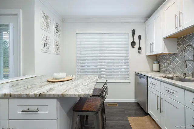 a kitchen with stainless steel appliances granite countertop a sink and a stove