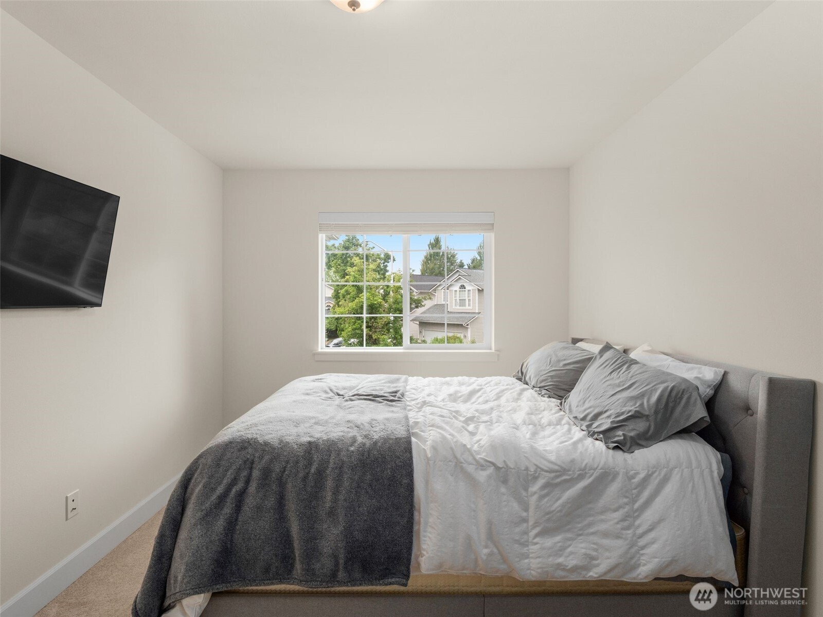 4620 151st Place Southeast Bothell, WA 98012 - Photo 19 of 33 a bedroom with a bed and a flat screen tv