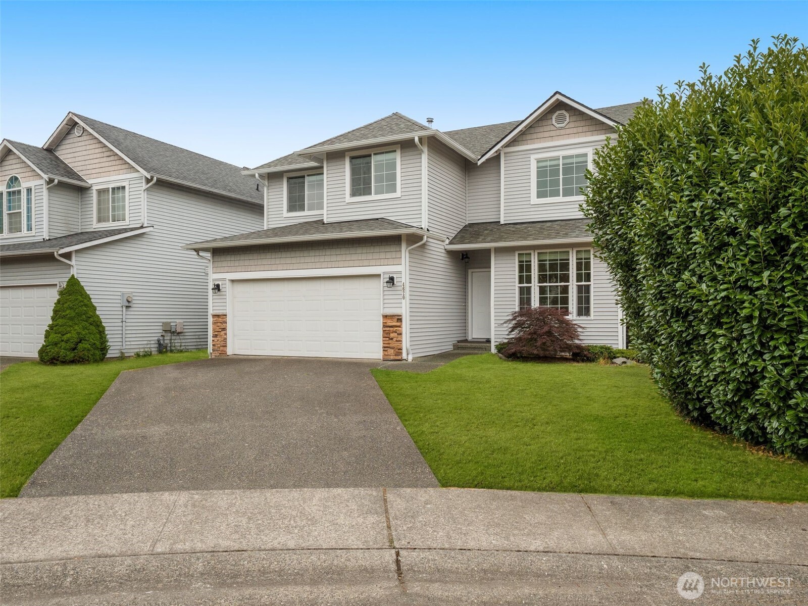 4620 151st Place Southeast Bothell, WA 98012 - Photo 2 of 33 a front view of a house with a garden and garage