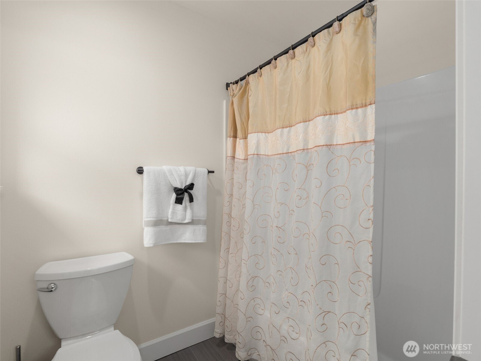 4620 151st Place Southeast Bothell, WA 98012 - Photo 21 of 33 a white toilet sitting next to a shower curtain