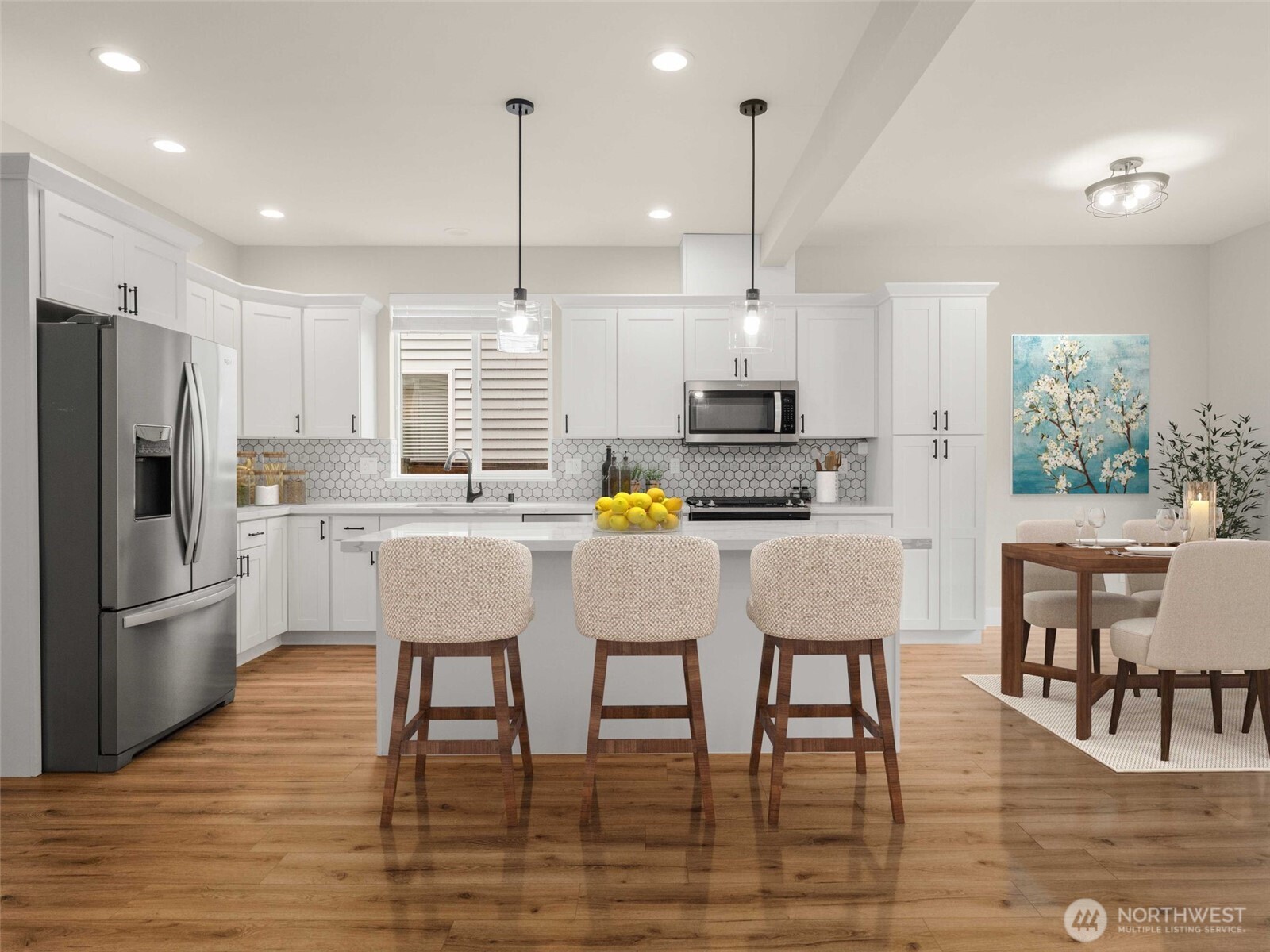 4620 151st Place Southeast Bothell, WA 98012 - Photo 3 of 33 a kitchen with kitchen island white cabinets and stainless steel appliances