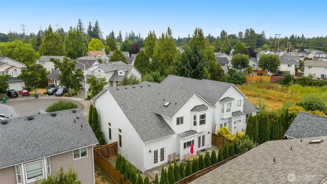 a aerial view of a house next to a yard