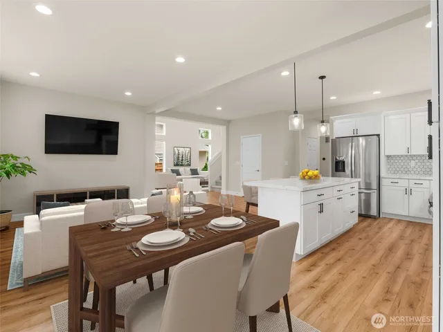 a open dining room with stainless steel appliances kitchen island granite countertop furniture and a kitchen view