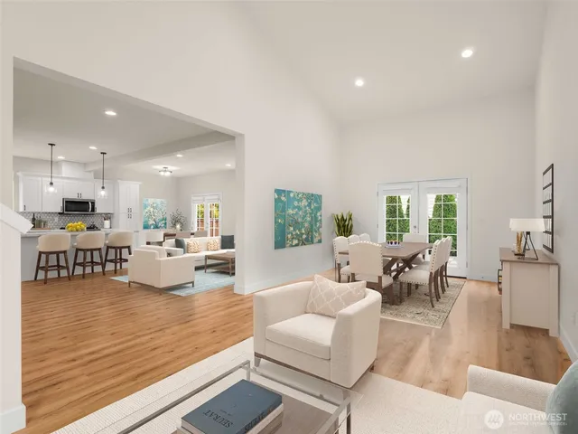 a living room with furniture kitchen view and a large window