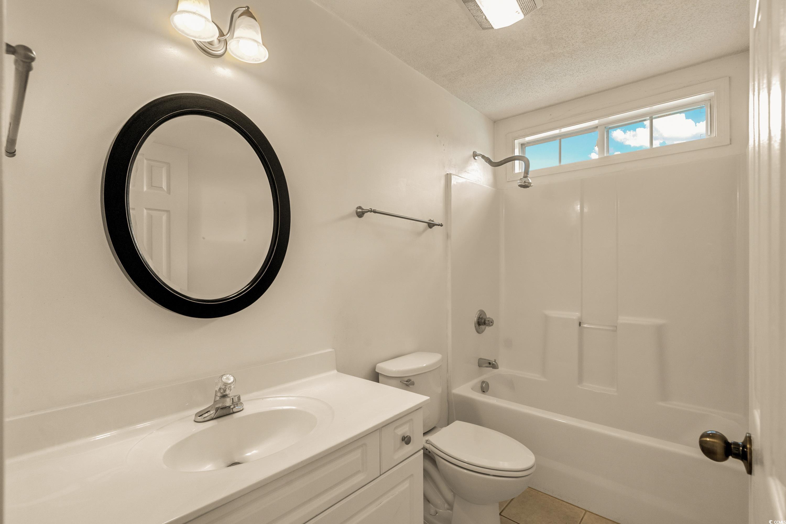 2001 Neath Court Myrtle Beach, SC 29588 - Photo 19 of 31 Bathroom featuring a textured ceiling, vanity, til