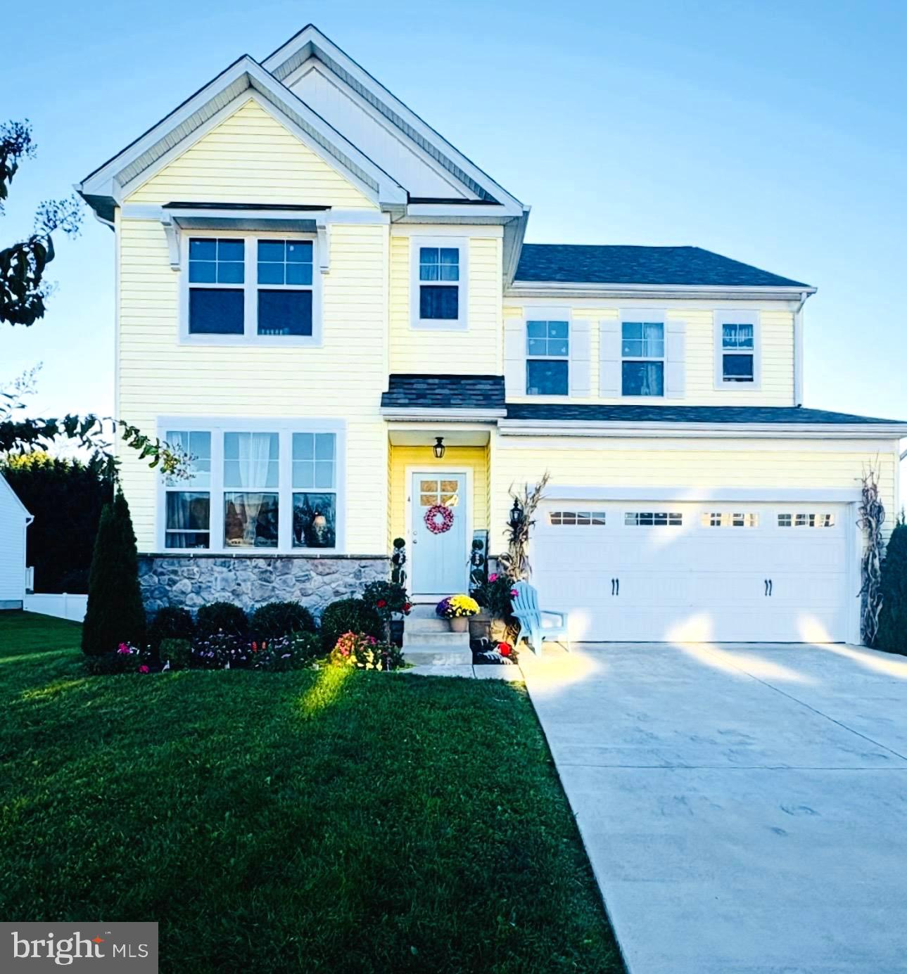 a front view of a house with a yard table and chairs
