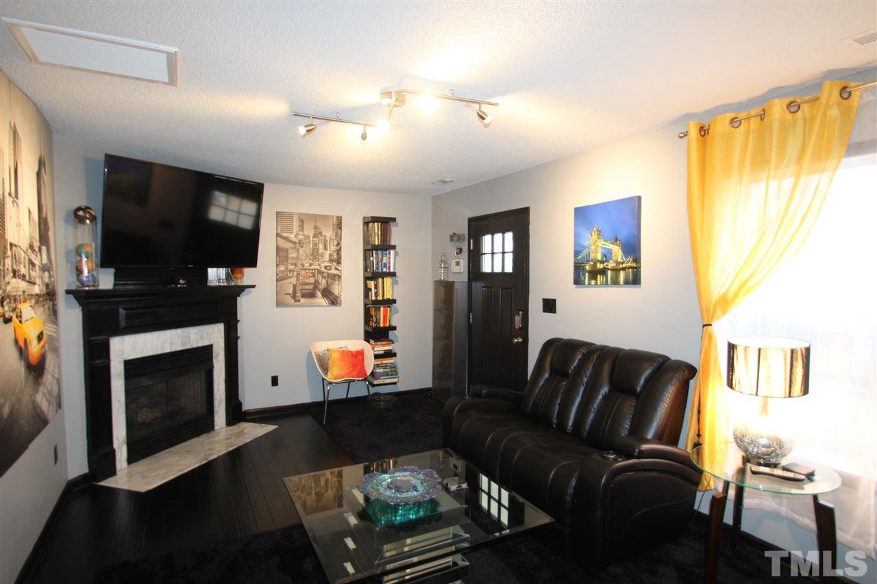 2501 Lilymount Drive Raleigh, NC 27610 - Photo 2 of 10 a living room with furniture and a flat screen tv