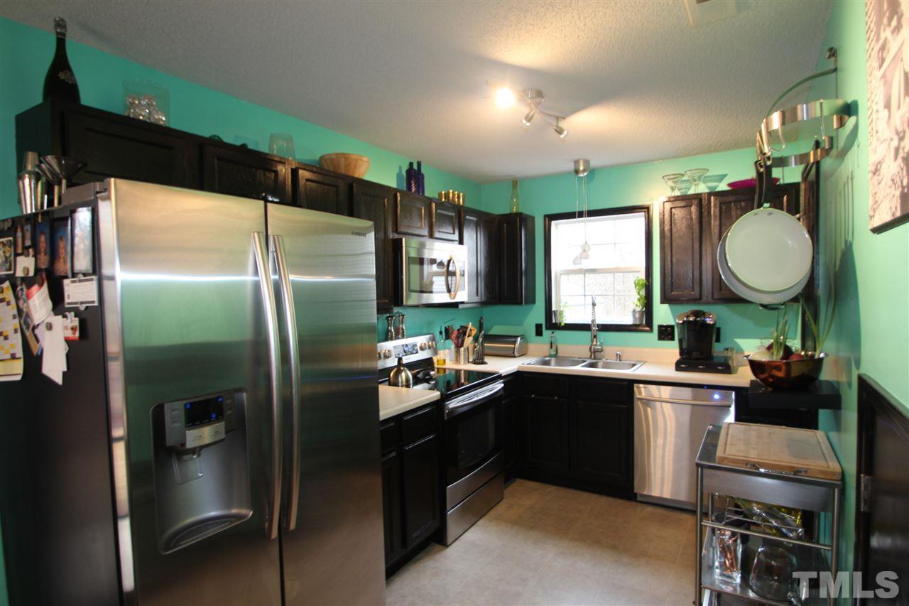 2501 Lilymount Drive Raleigh, NC 27610 - Photo 4 of 10 a kitchen with a sink stainless steel appliances and cabinets