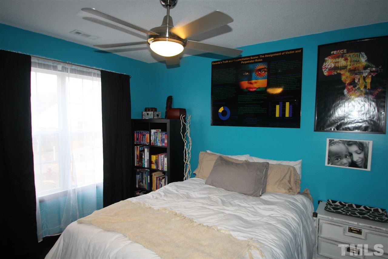 2501 Lilymount Drive Raleigh, NC 27610 - Photo 6 of 10 a bed room with a bed and a television