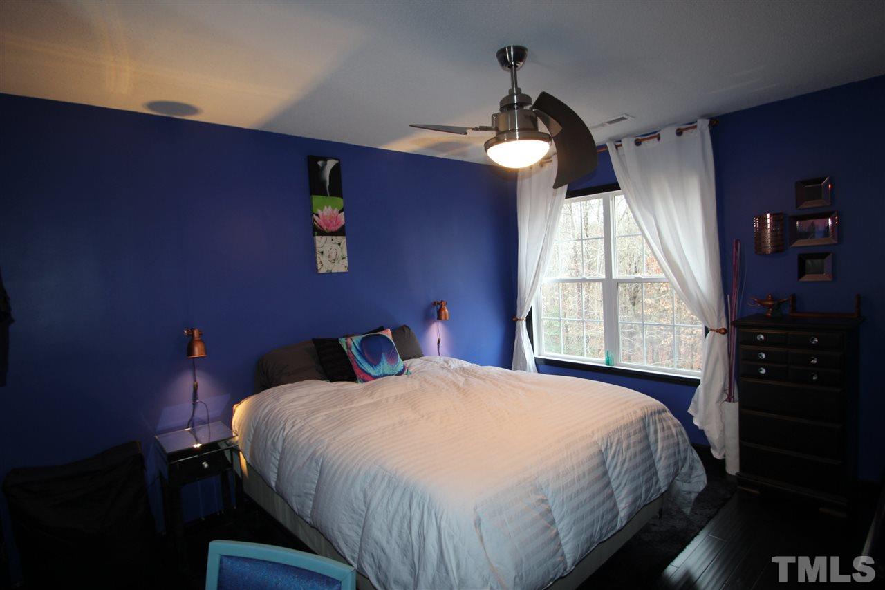 2501 Lilymount Drive Raleigh, NC 27610 - Photo 7 of 10 a bedroom with a bed and a large window