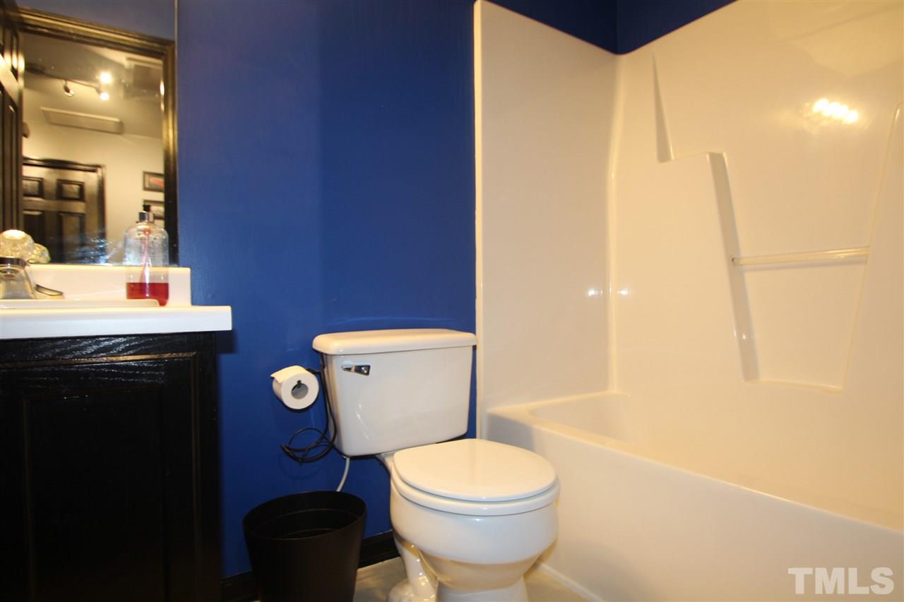 2501 Lilymount Drive Raleigh, NC 27610 - Photo 9 of 10 a bathroom with a toilet a sink and mirror