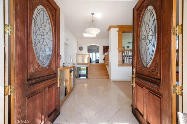 a view of a hallway with wooden floor and a living room