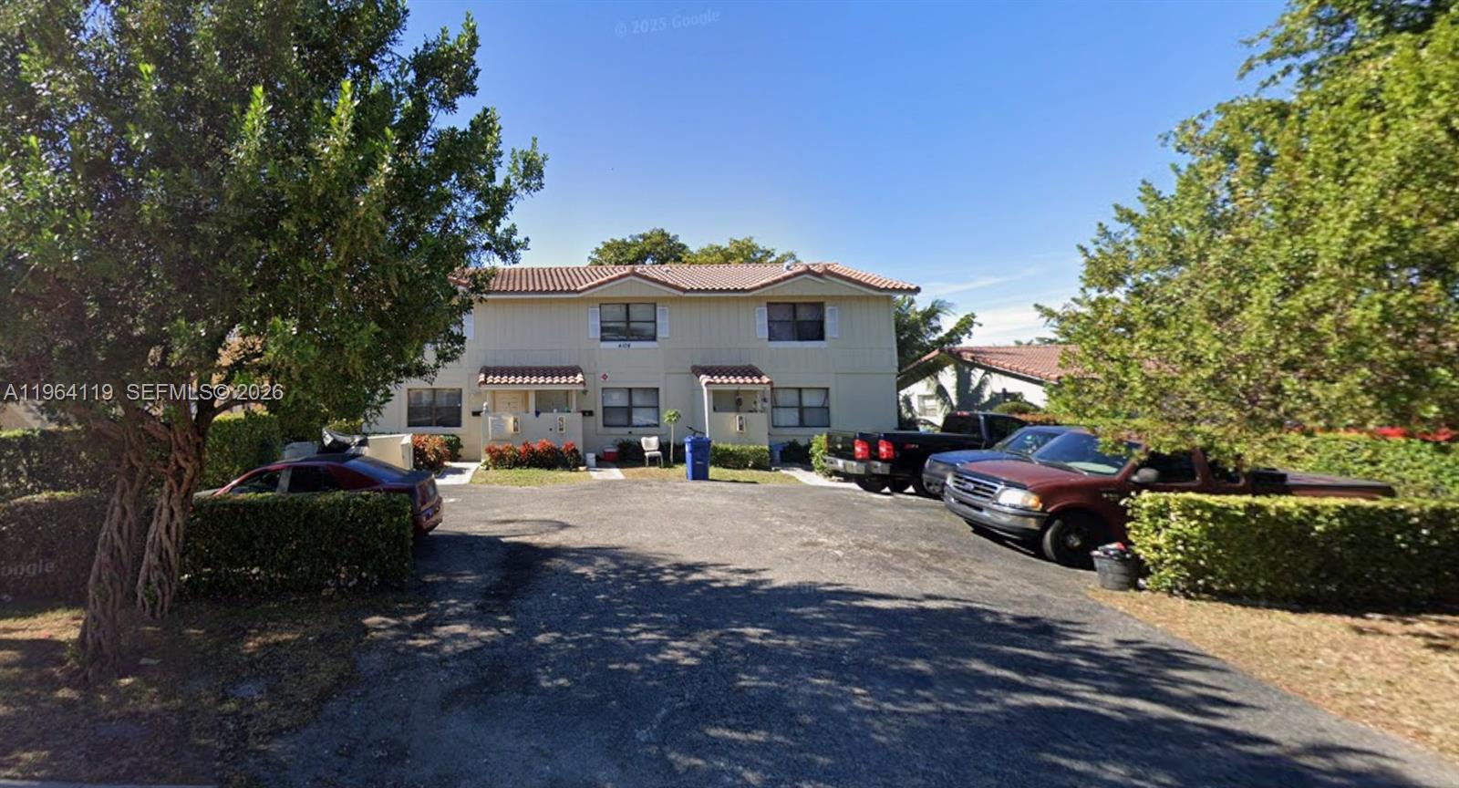 4108 Riverside Drive, Unit 2 Coral Springs, FL 33065 - Photo 11 of 11 a front view of a house with a yard and garage