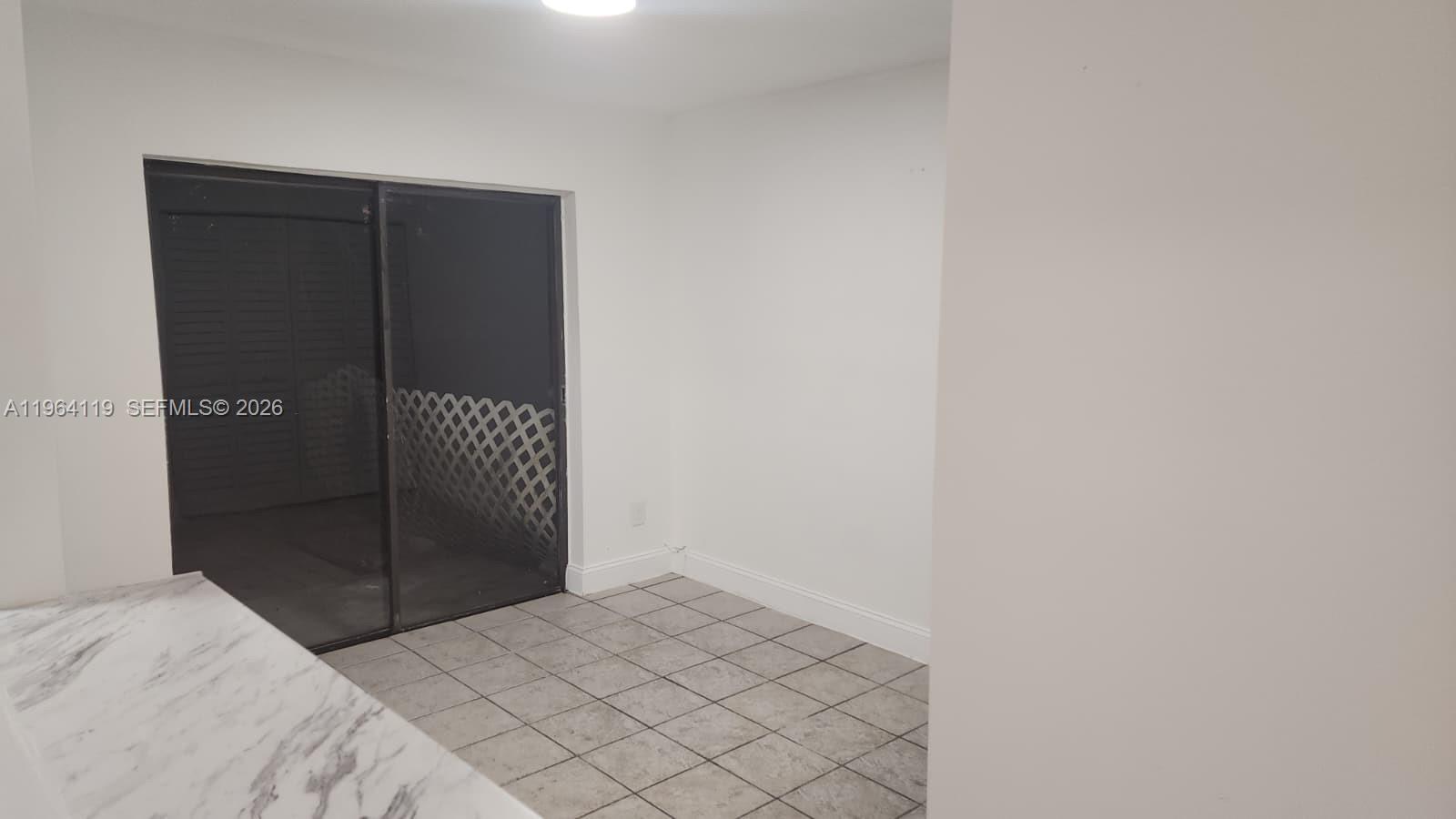 4108 Riverside Drive, Unit 2 Coral Springs, FL 33065 - Photo 3 of 11 a bedroom with a bed and a closet