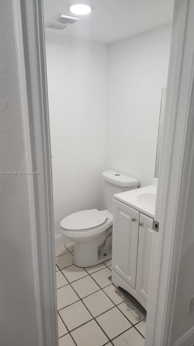 4108 Riverside Drive, Unit 2 Coral Springs, FL 33065 - Photo 4 of 11 a white toilet sitting next to a white sink and vanity