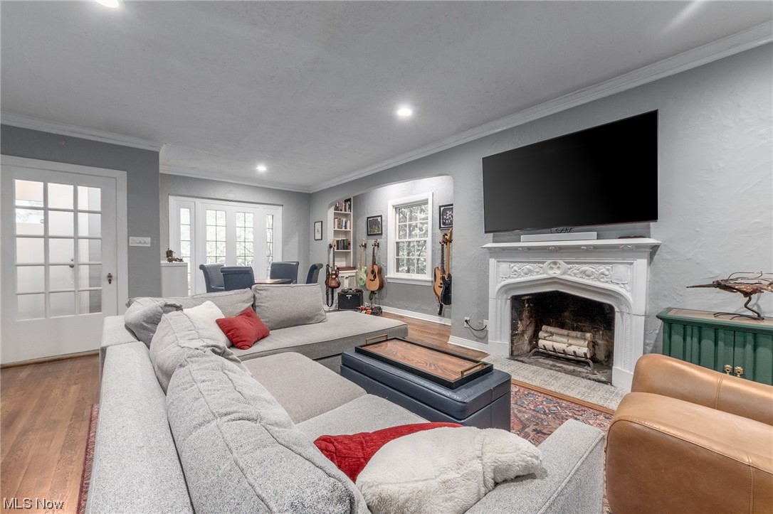 Hardwood floored living room with ornamental molding