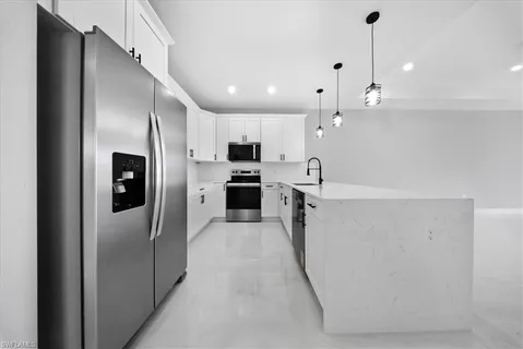 a large kitchen with cabinets and stainless steel appliances