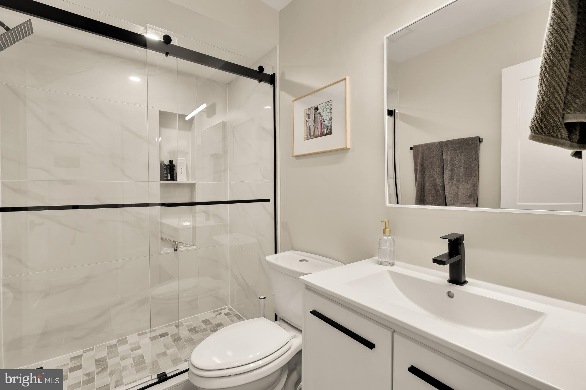 3361 18th Street Northwest Washington, DC 20010 - Photo 35 of 49 a bathroom with a sink toilet a mirror and shower