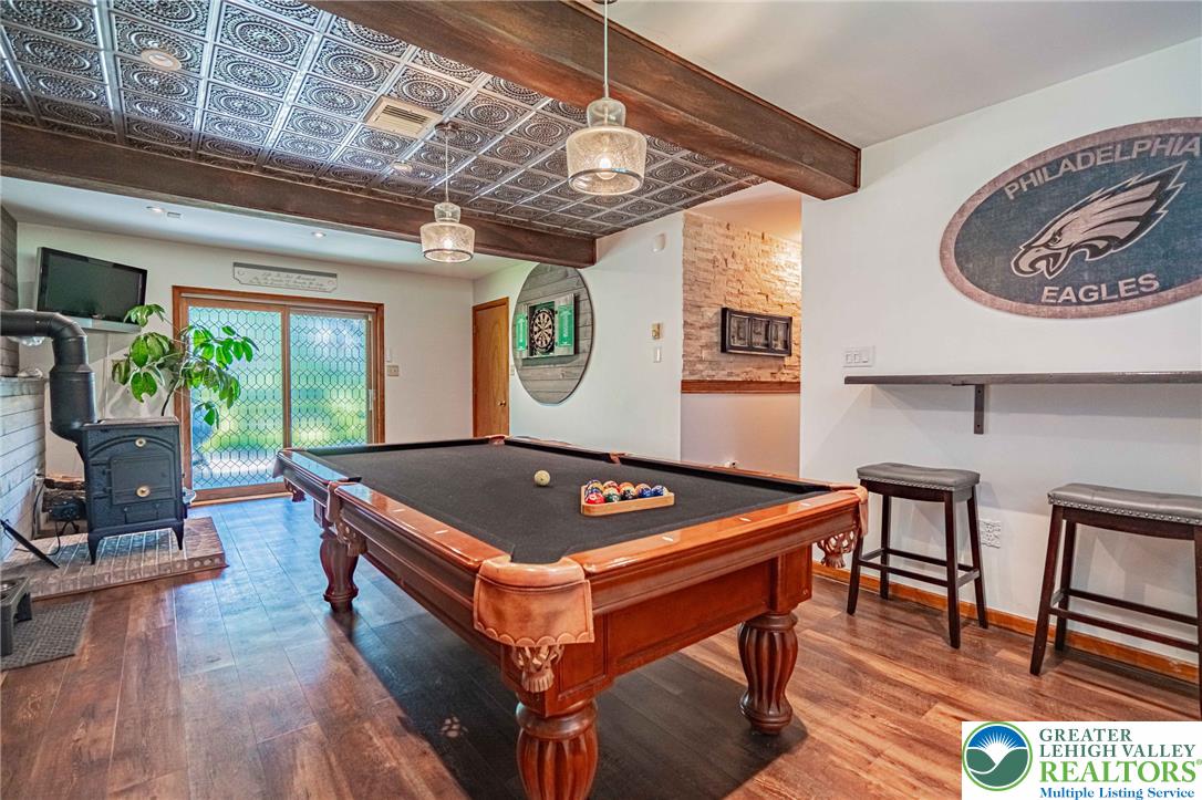 341 Lower Greenhill Road Kunkletown, PA 18058 - Photo 35 of 69 A classic billiard room with exposed beams and a wood/coal-burning stove provides a welcoming entertainment space.