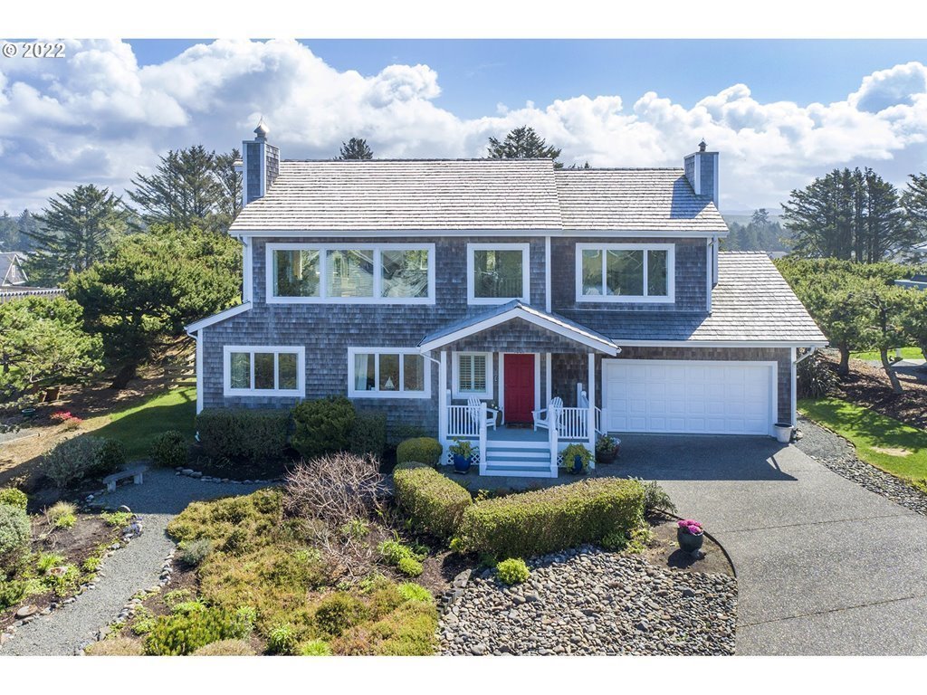 4805 High Ridge Road Gearhart, OR 97138 - Photo 1 of 29 a front view of a house with a garden