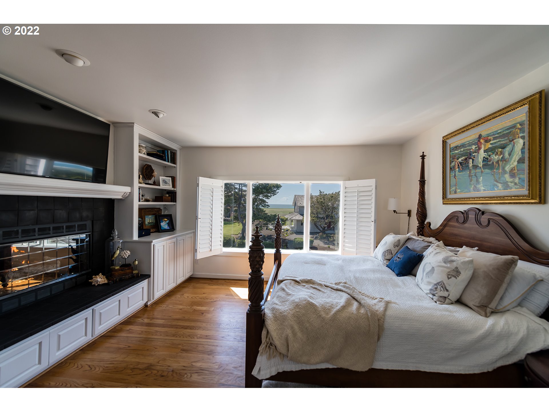 4805 High Ridge Road Gearhart, OR 97138 - Photo 13 of 29 a bedroom with a large bed and a fireplace