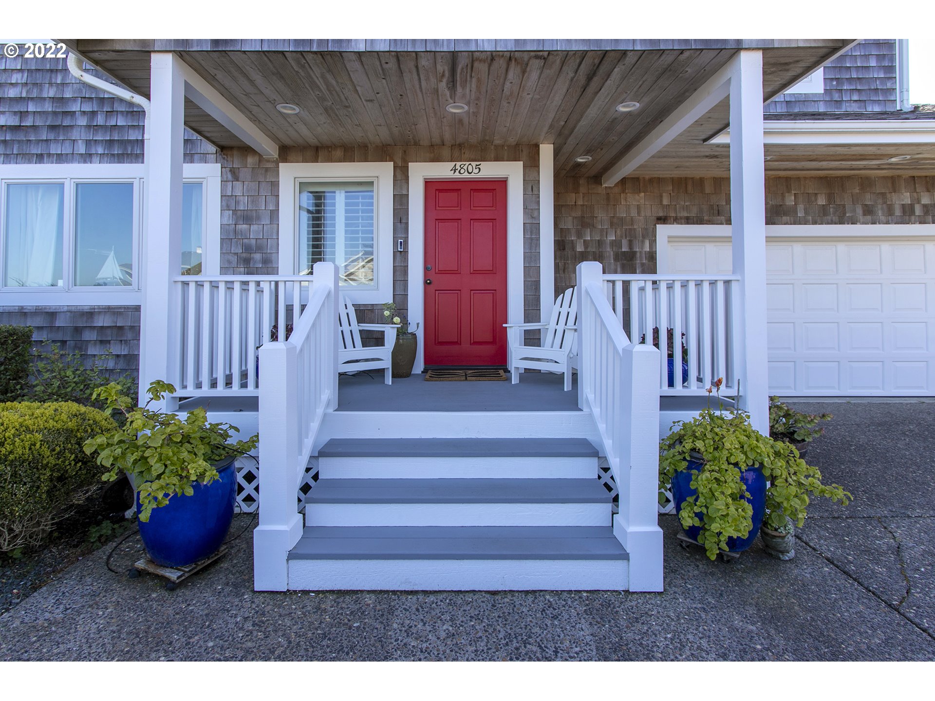 4805 High Ridge Road Gearhart, OR 97138 - Photo 2 of 29 a view of a house with a flower garden