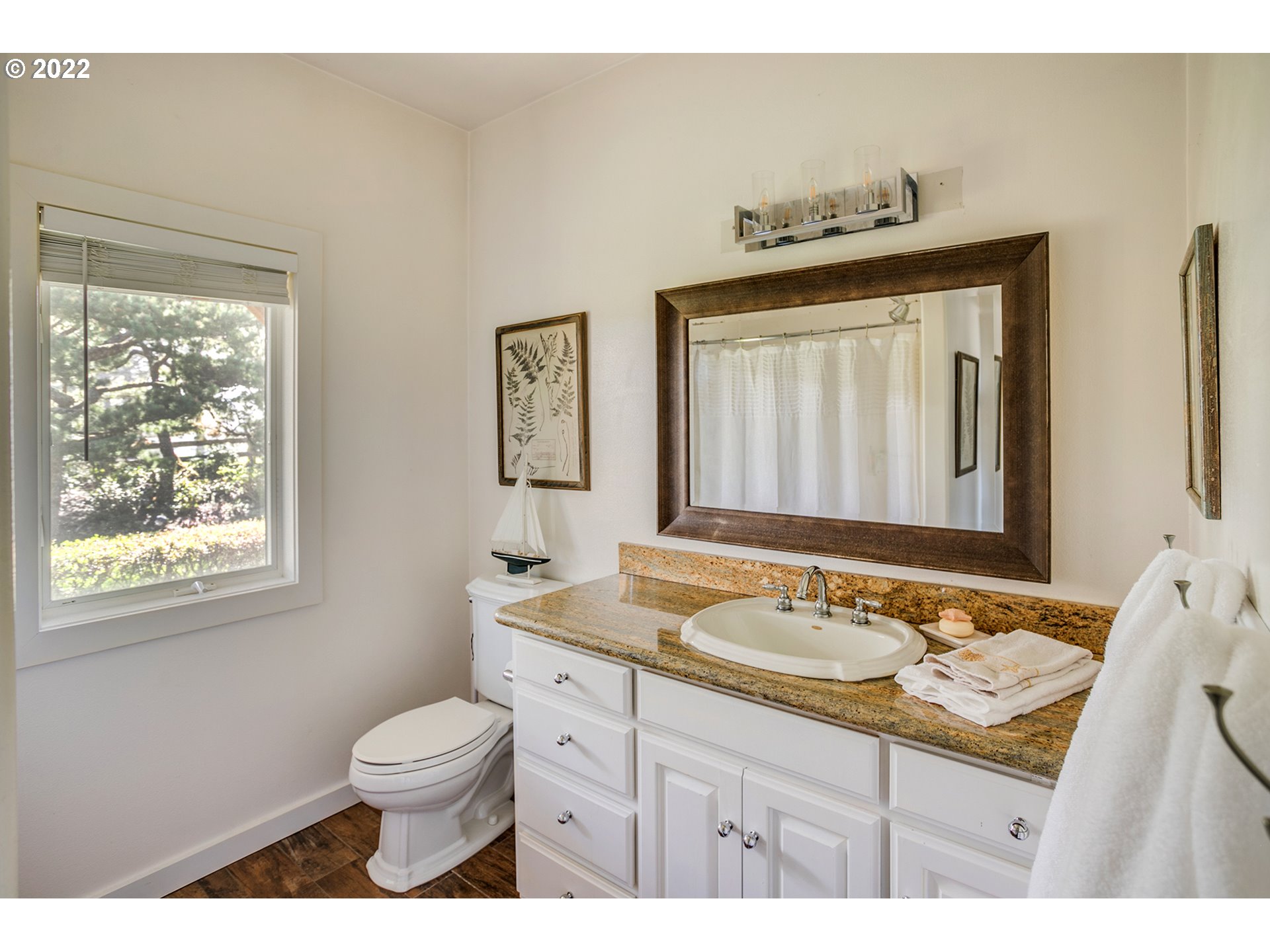 4805 High Ridge Road Gearhart, OR 97138 - Photo 23 of 29 a bathroom with a granite countertop sink mirror vanity and toilet