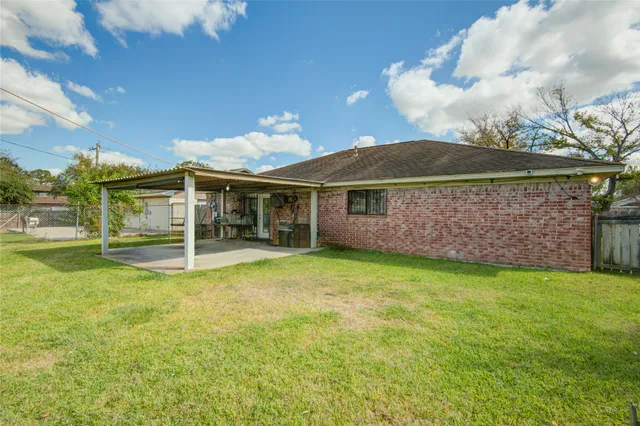 a view of a house with a backyard and a patio