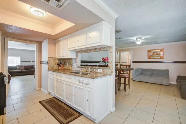 a kitchen with stainless steel appliances a stove top oven and a refrigerator