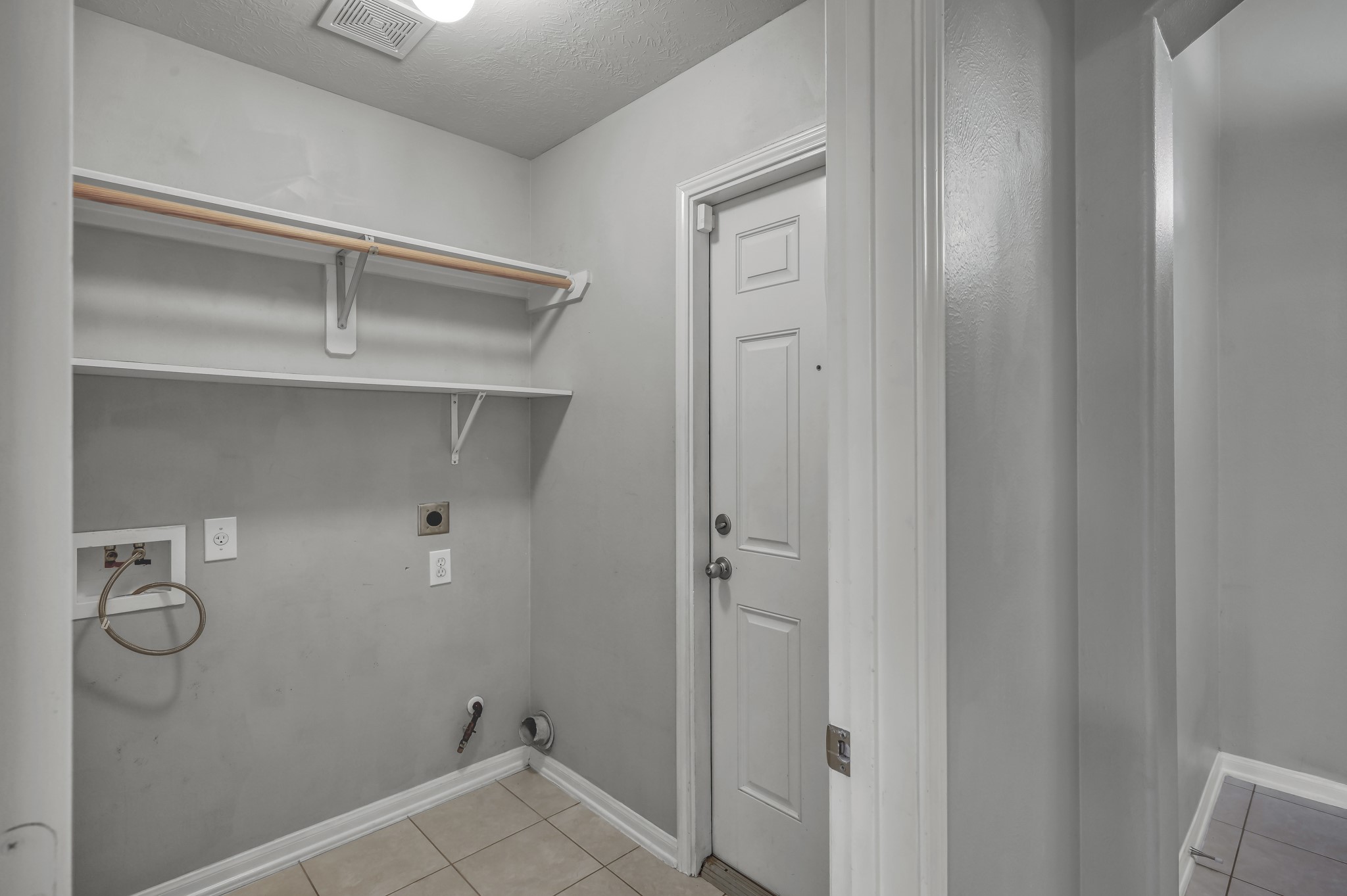 21331 Timber Pines Drive Spring, TX 77388 - Photo 11 of 22 The utility room features shelving and rods for storage and hanging clothes to dry!