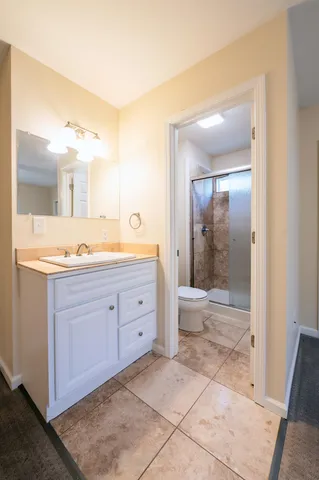 a bathroom with a granite countertop sink mirror and bathtub