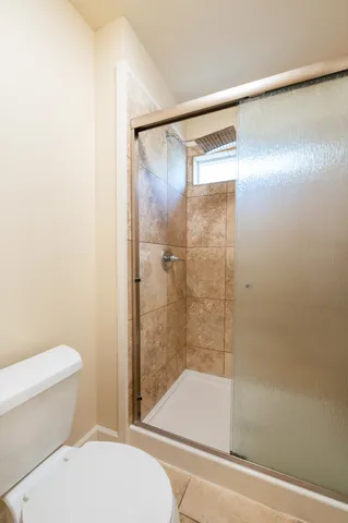 a bathroom with a shower and a toilet