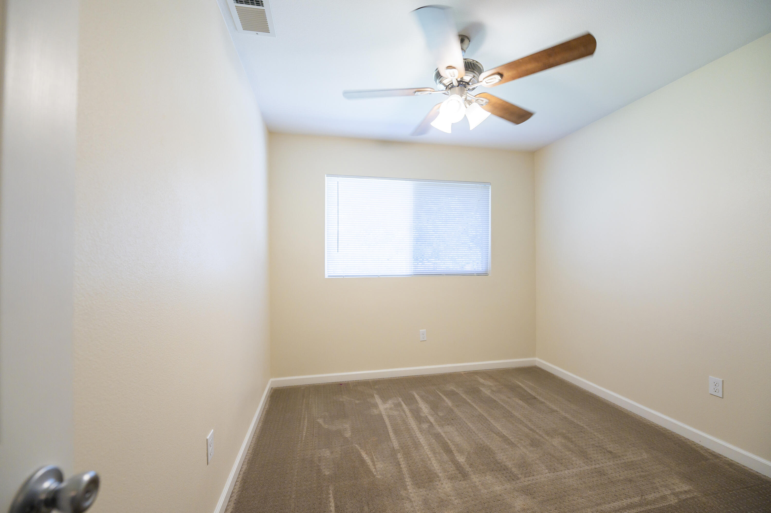 601 Green Street Willows, CA 95988 - Photo 17 of 23 an empty room with a window and a fan