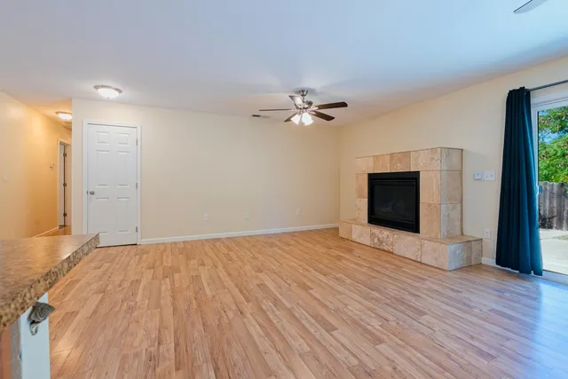 wooden floor in an empty room with a fireplace