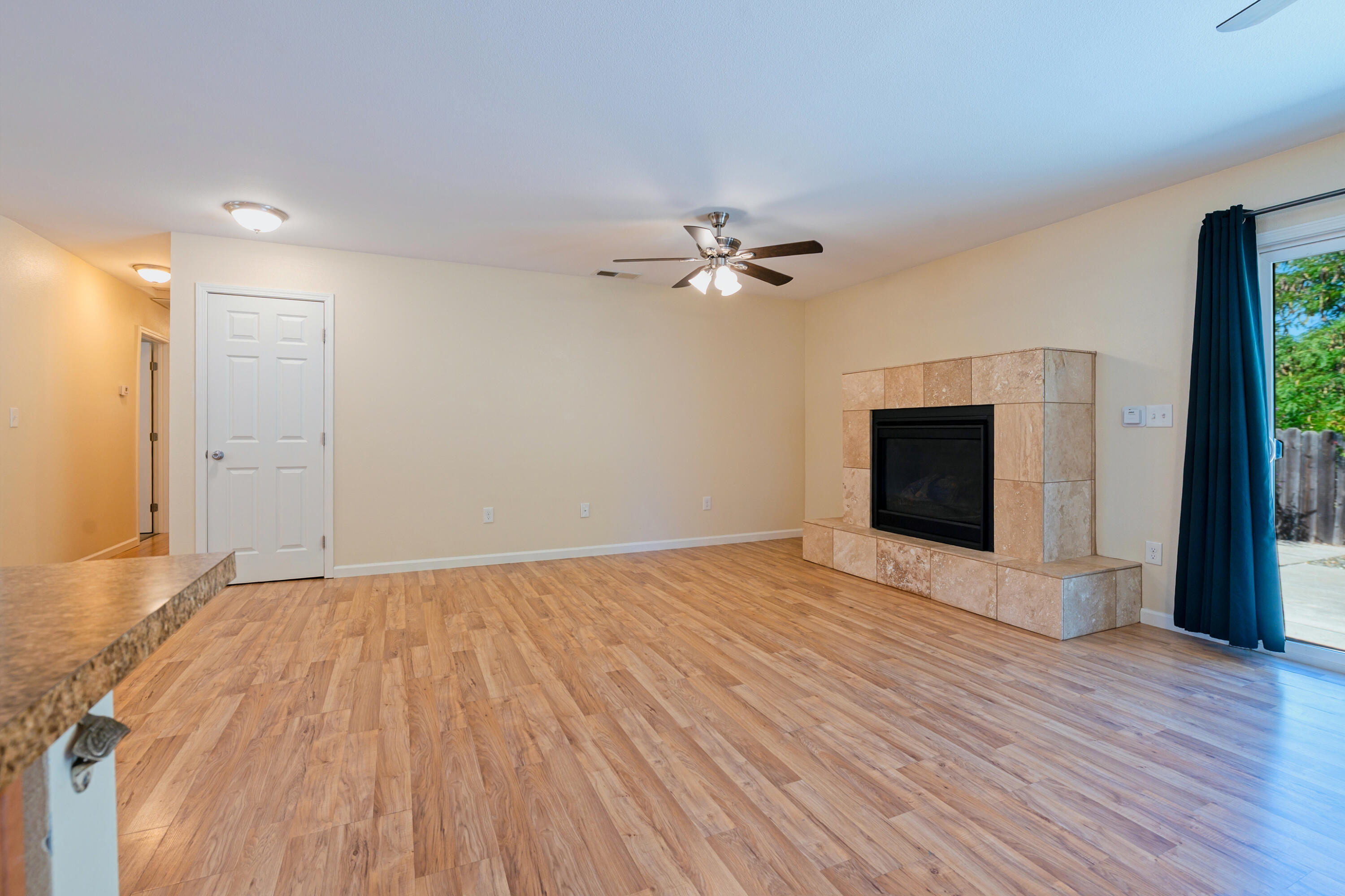601 Green Street Willows, CA 95988 - Photo 6 of 23 wooden floor in an empty room with a fireplace