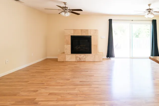 a view of a room with wooden floor and white walls