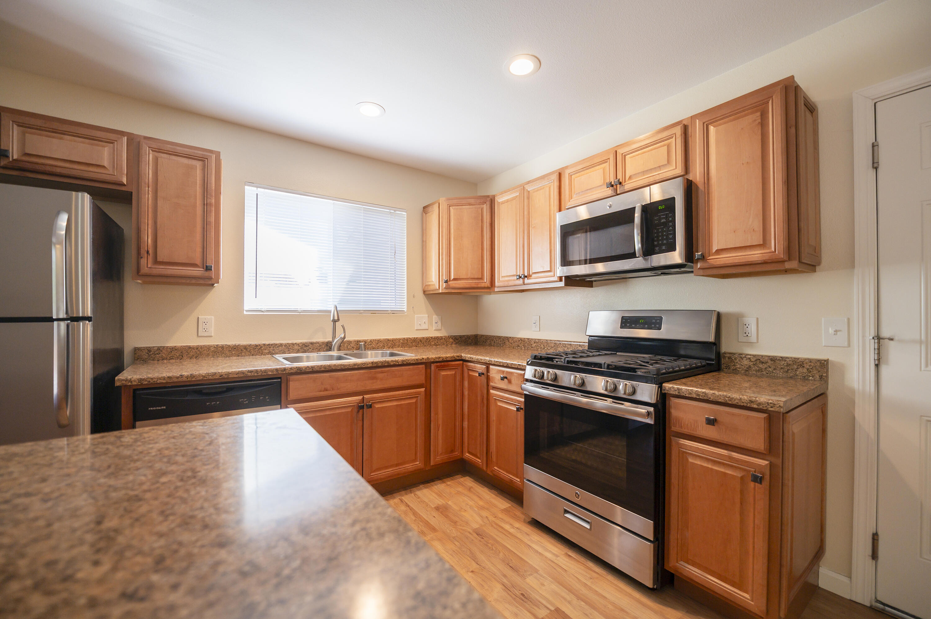 601 Green Street Willows, CA 95988 - Photo 8 of 23 a kitchen with stainless steel appliances granite countertop a stove sink microwave and refrigerator