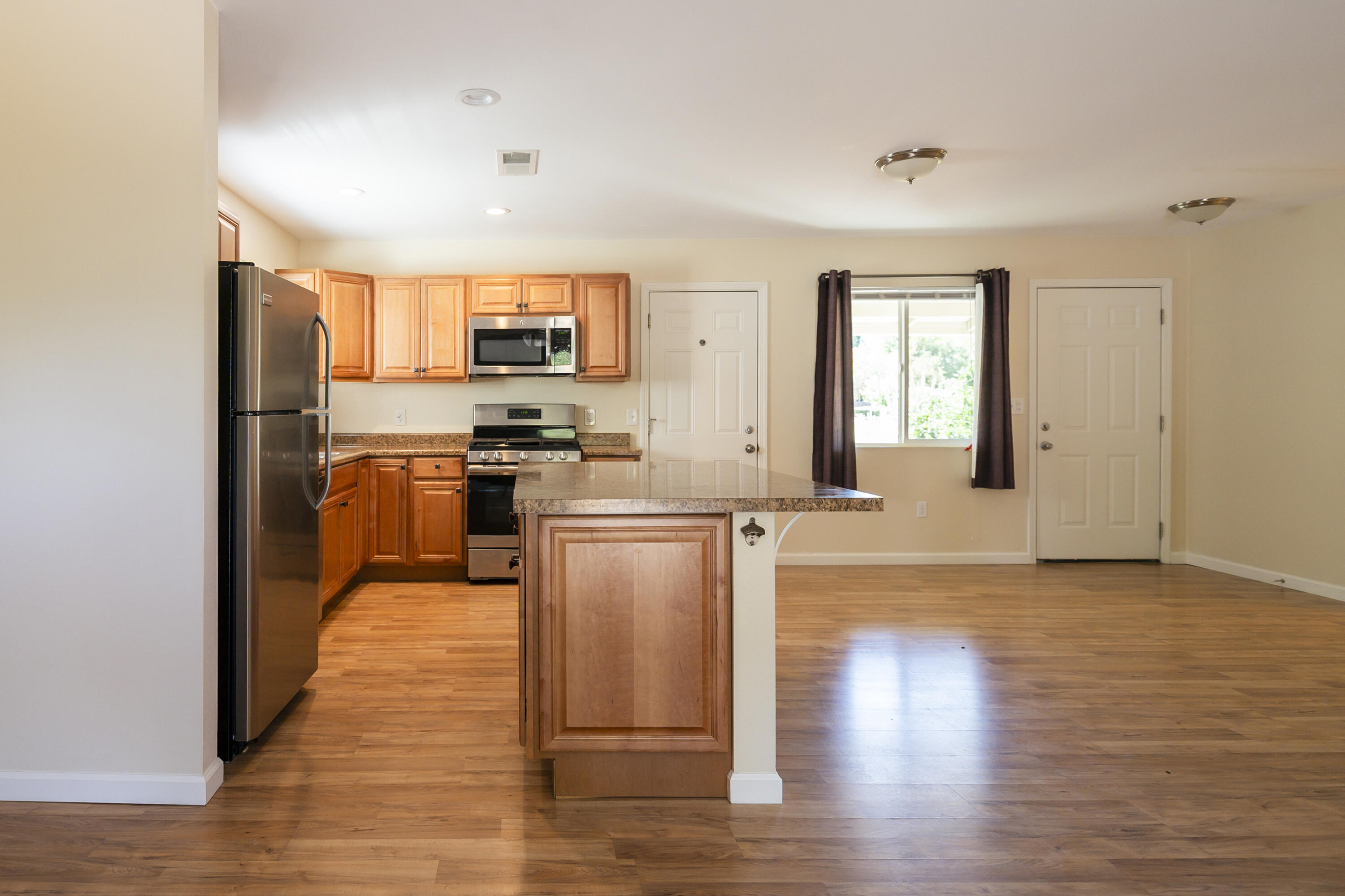 601 Green Street Willows, CA 95988 - Photo 9 of 23 a kitchen with stainless steel appliances granite countertop a stove top oven a sink and a refrigerator