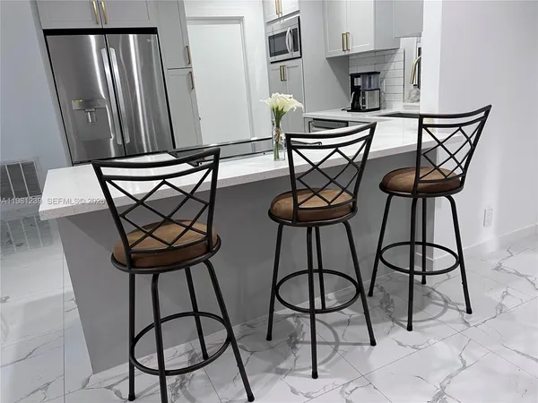 a view of a chairs and table in a kitchen