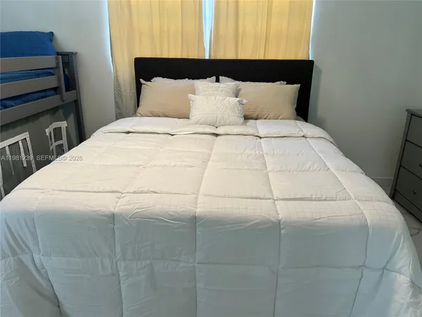 a large white bed in a small room