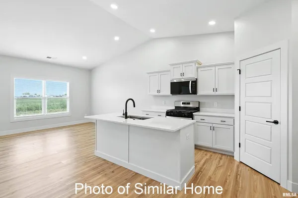 a kitchen with stainless steel appliances a sink stove and refrigerator