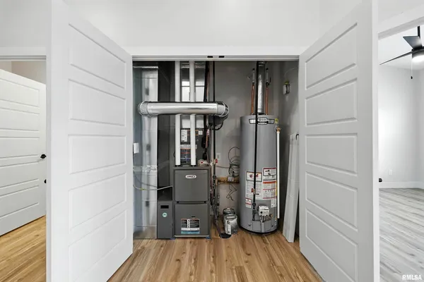 a view of walk in closet with wooden floor and closet