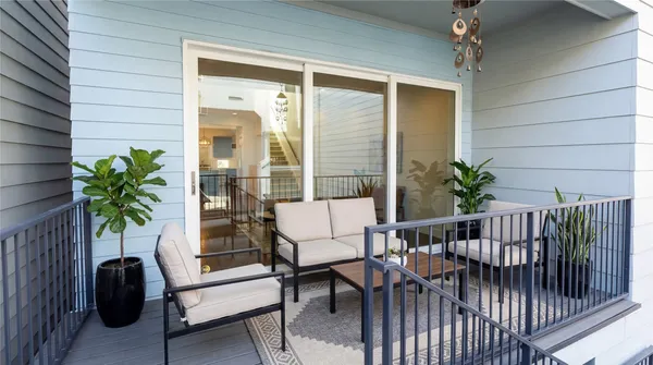 a view of a balcony with furniture and a potted plant