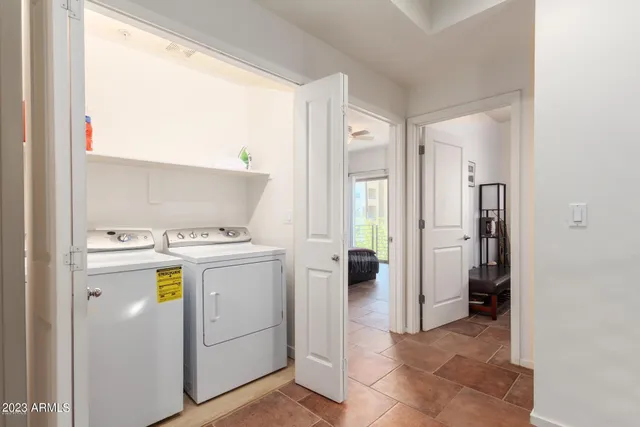 a bedroom with a bed and a potted plant