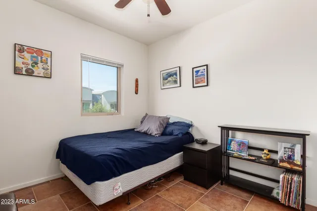 a bedroom with a bed and a window