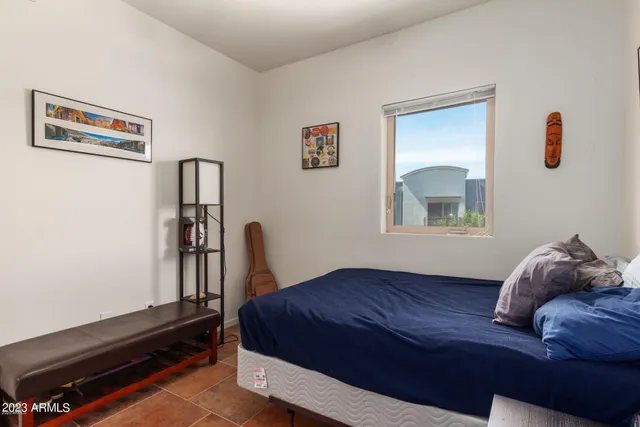 a bedroom with a bed and a table