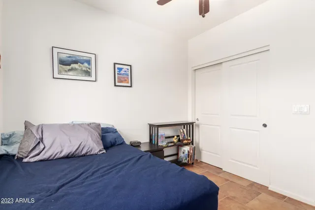 a bedroom with a bed and a large window