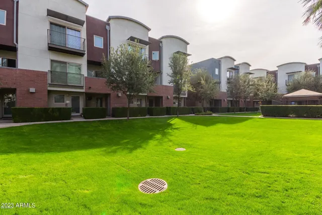 a front view of a building with a garden