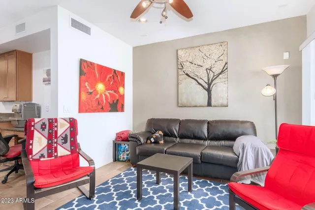 a living room with furniture and a rug